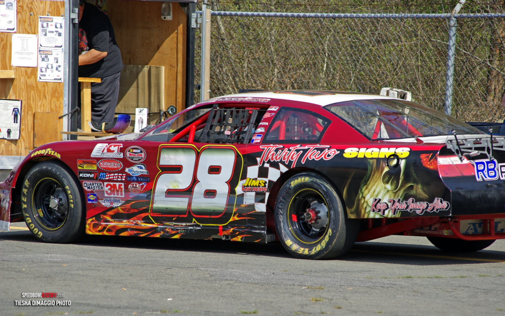 Black and white abstract pattern with concentric circles and wave shapes.