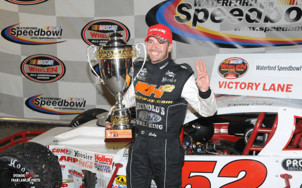 Black and white abstract pattern with concentric circles and wave shapes.