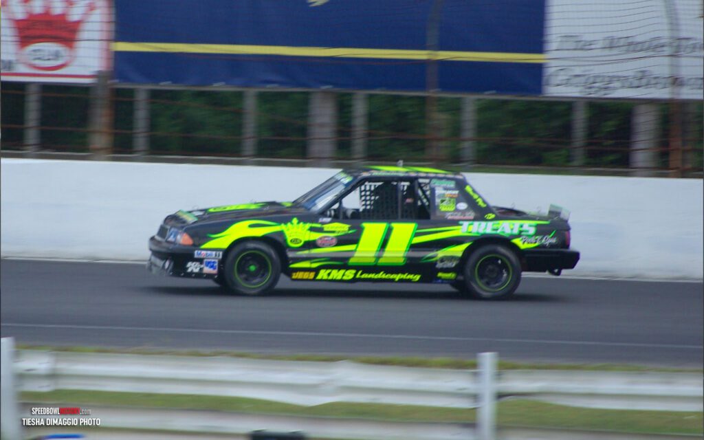 Black and white abstract pattern with concentric circles and wave shapes.