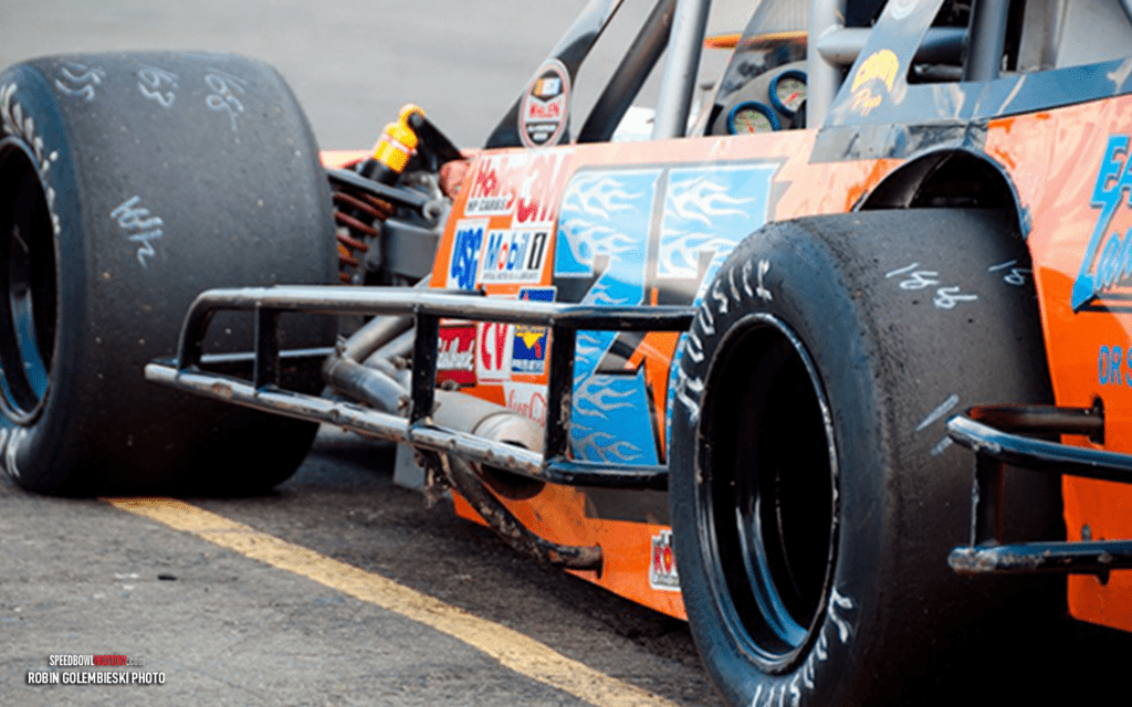 Black and white abstract pattern with concentric circles and wave shapes.