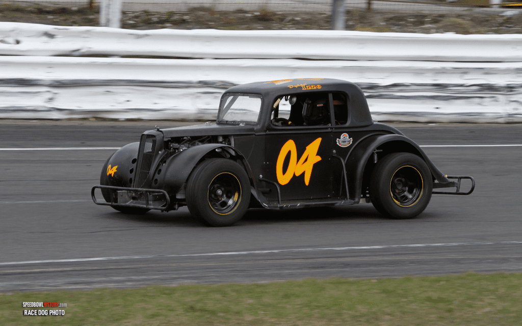 Black and white abstract pattern with concentric circles and wave shapes.