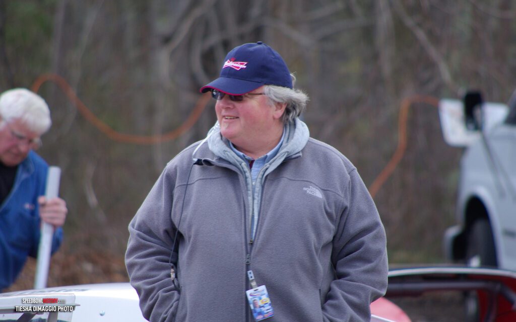 Black and white abstract pattern with concentric circles and wave shapes.