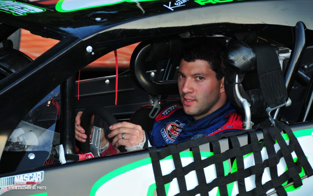 Black and white abstract pattern with concentric circles and wave shapes.