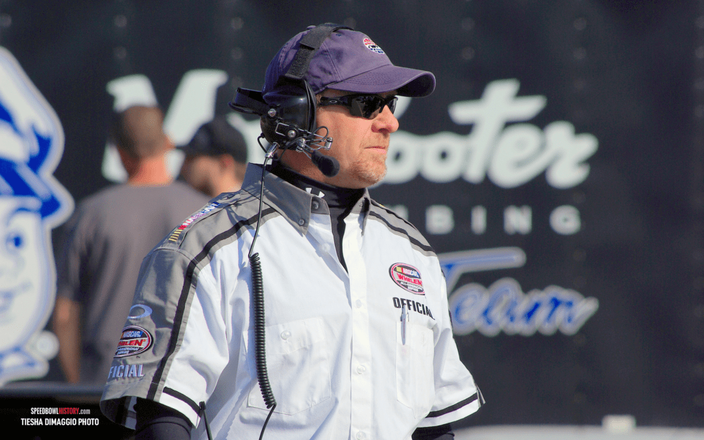 Black and white abstract pattern with concentric circles and wave shapes.