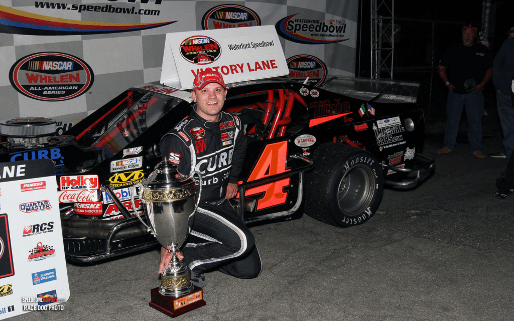 Black and white abstract pattern with concentric circles and wave shapes.