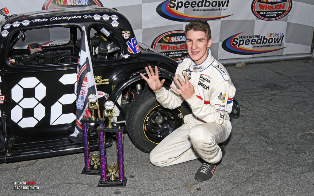 Black and white abstract pattern with concentric circles and wave shapes.