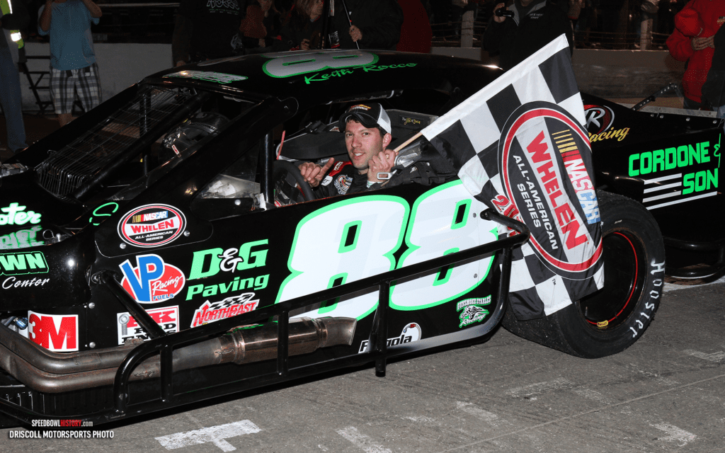 Black and white abstract pattern with concentric circles and wave shapes.