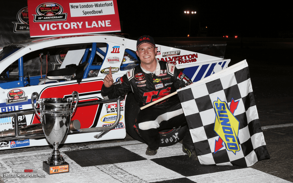 Black and white abstract pattern with concentric circles and wave shapes.