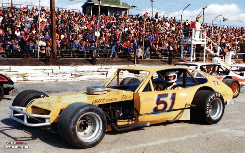 Black and white abstract pattern with concentric circles and wave shapes.