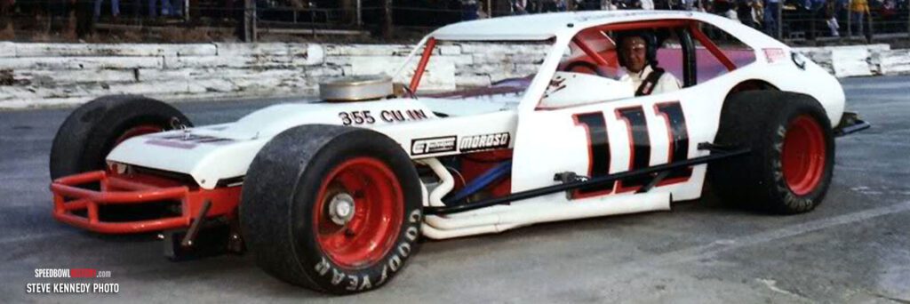 Black and white abstract pattern with concentric circles and wave shapes.