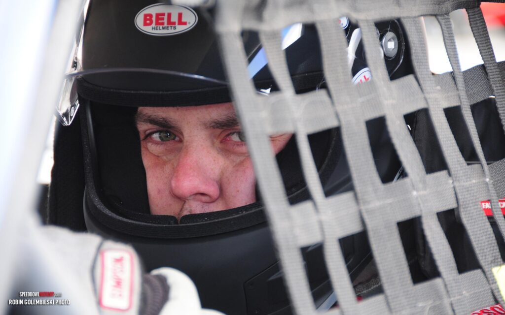 Black and white abstract pattern with concentric circles and wave shapes.