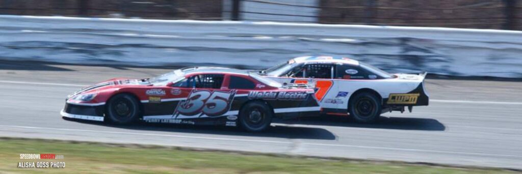 Black and white abstract pattern with concentric circles and wave shapes.