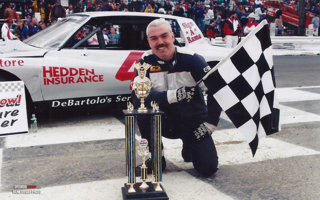 Black and white abstract pattern with concentric circles and wave shapes.