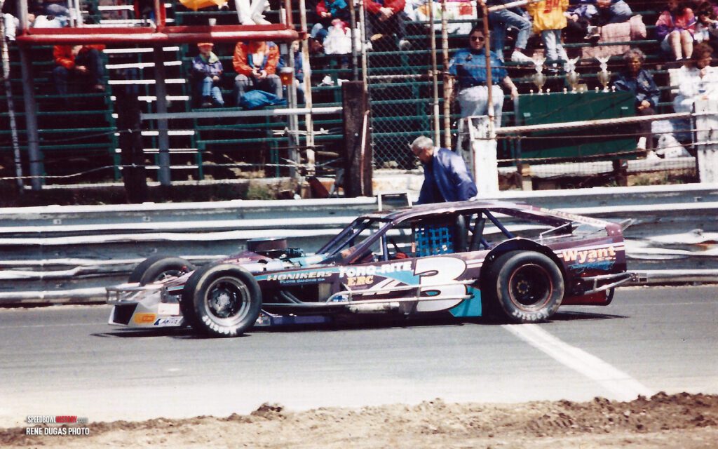 Black and white abstract pattern with concentric circles and wave shapes.