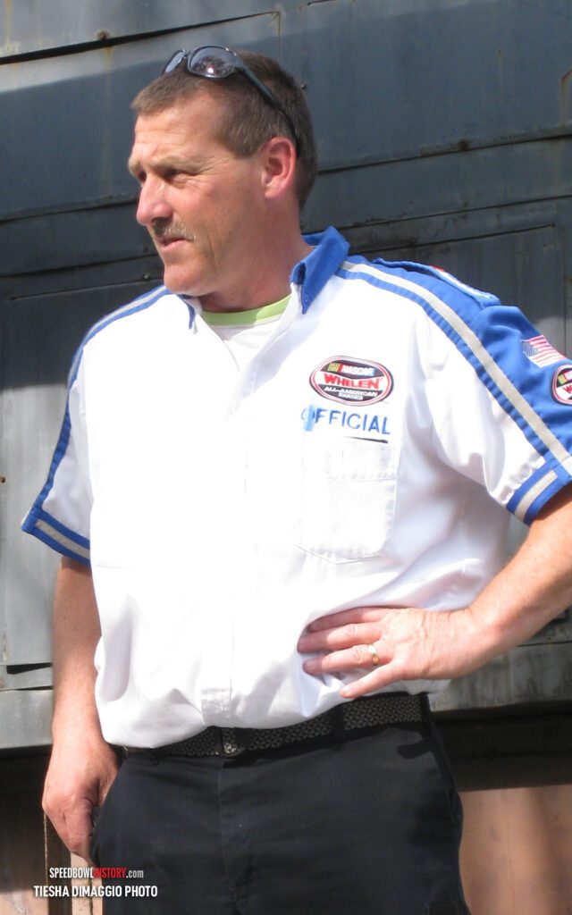 Black and white abstract pattern with concentric circles and wave shapes.