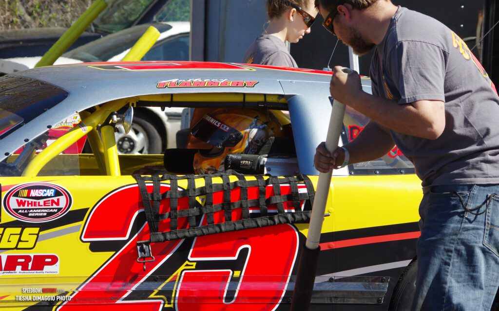 Black and white abstract pattern with concentric circles and wave shapes.