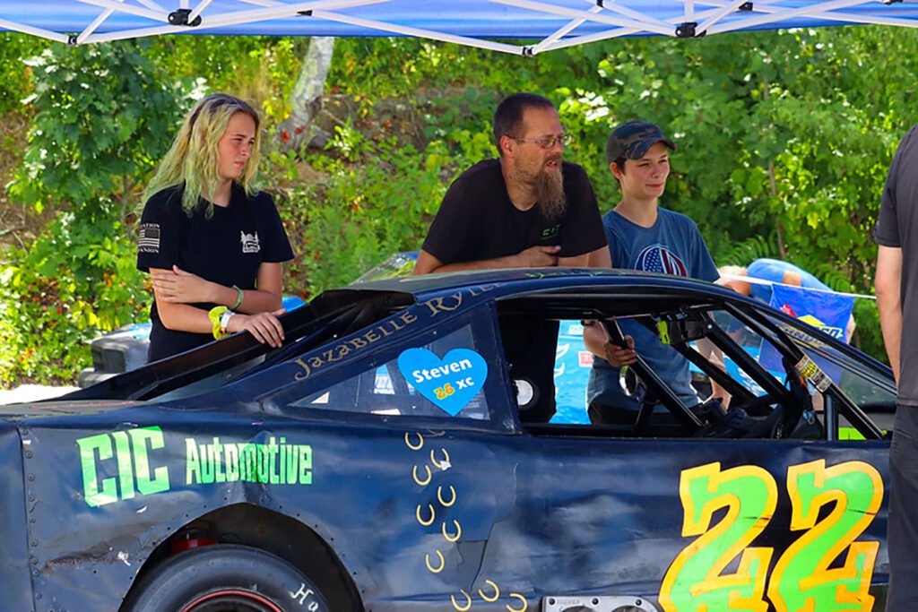 Black and white abstract pattern with concentric circles and wave shapes.