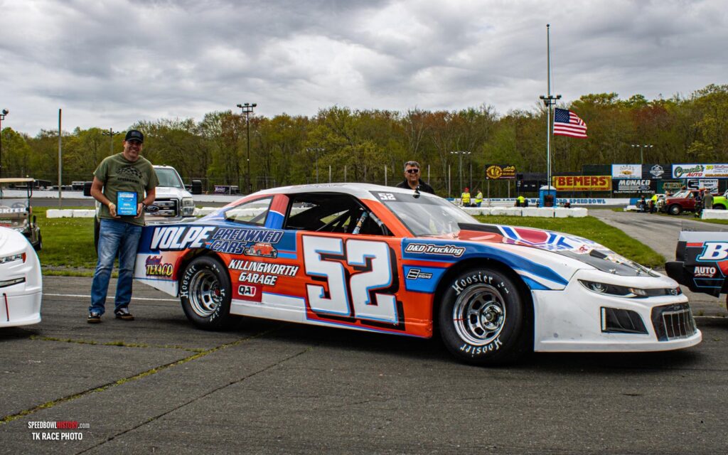 Black and white abstract pattern with concentric circles and wave shapes.