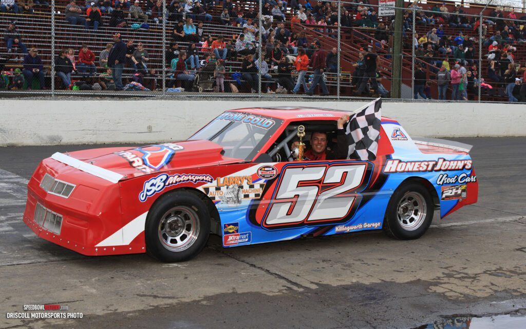 Black and white abstract pattern with concentric circles and wave shapes.