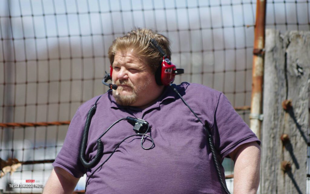 Black and white abstract pattern with concentric circles and wave shapes.