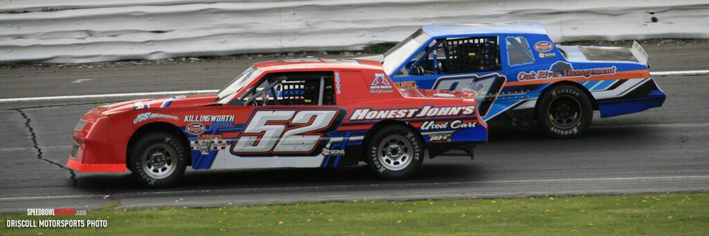 Black and white abstract pattern with concentric circles and wave shapes.