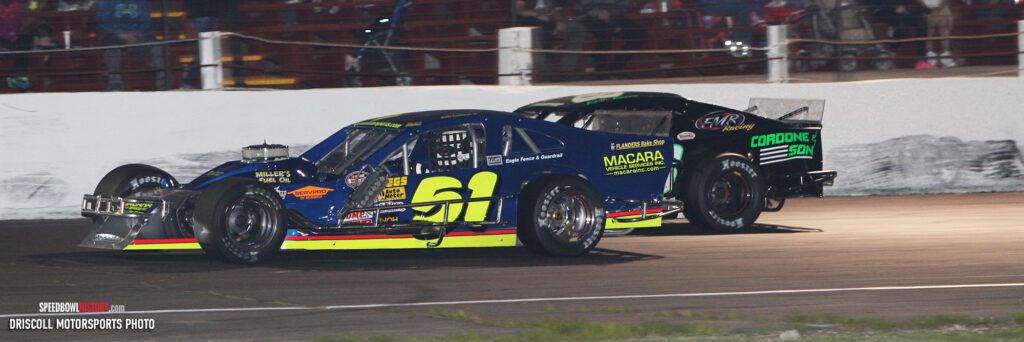 Black and white abstract pattern with concentric circles and wave shapes.