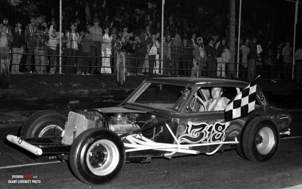 Black and white abstract pattern with concentric circles and wave shapes.