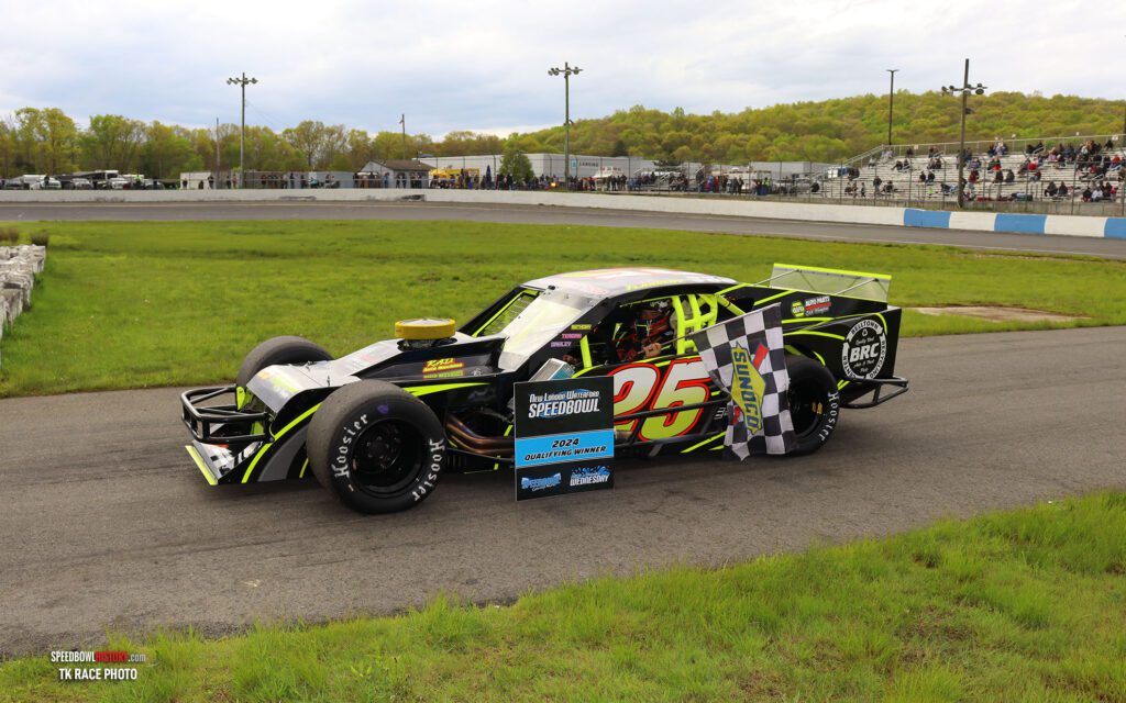 Black and white abstract pattern with concentric circles and wave shapes.