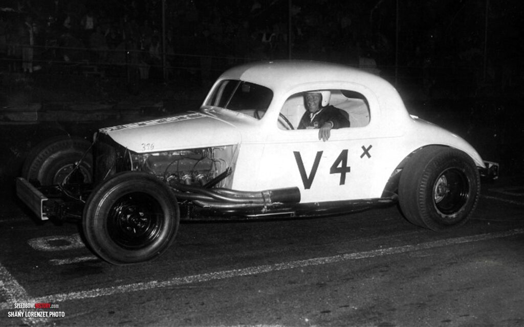 Black and white abstract pattern with concentric circles and wave shapes.