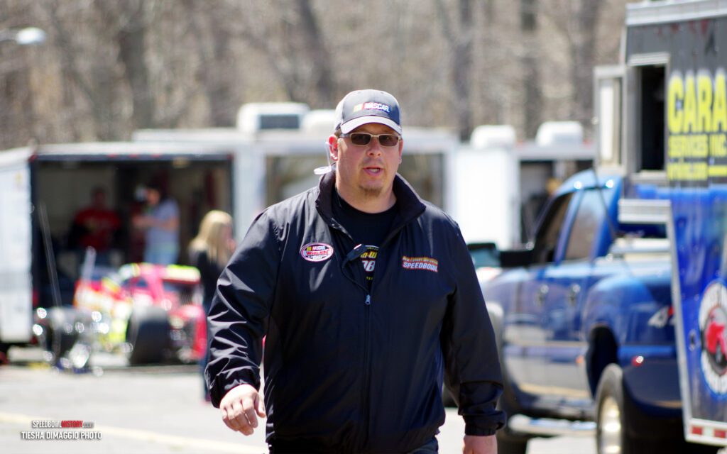 Black and white abstract pattern with concentric circles and wave shapes.