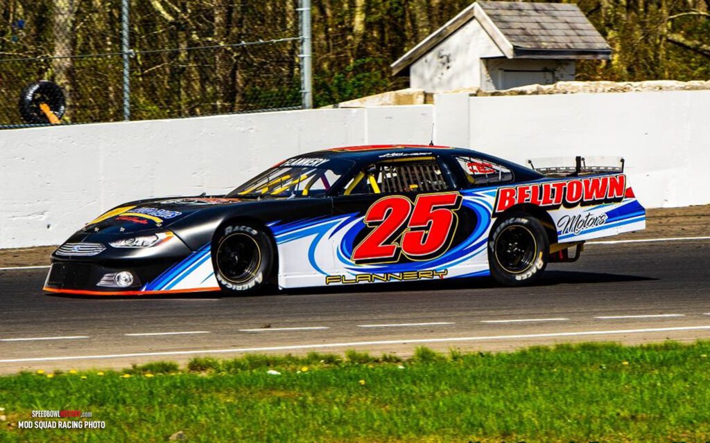 Black and white abstract pattern with concentric circles and wave shapes.