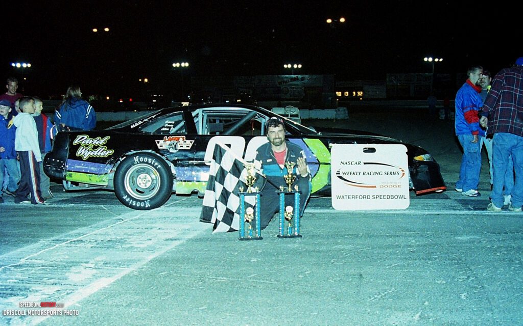 Black and white abstract pattern with concentric circles and wave shapes.