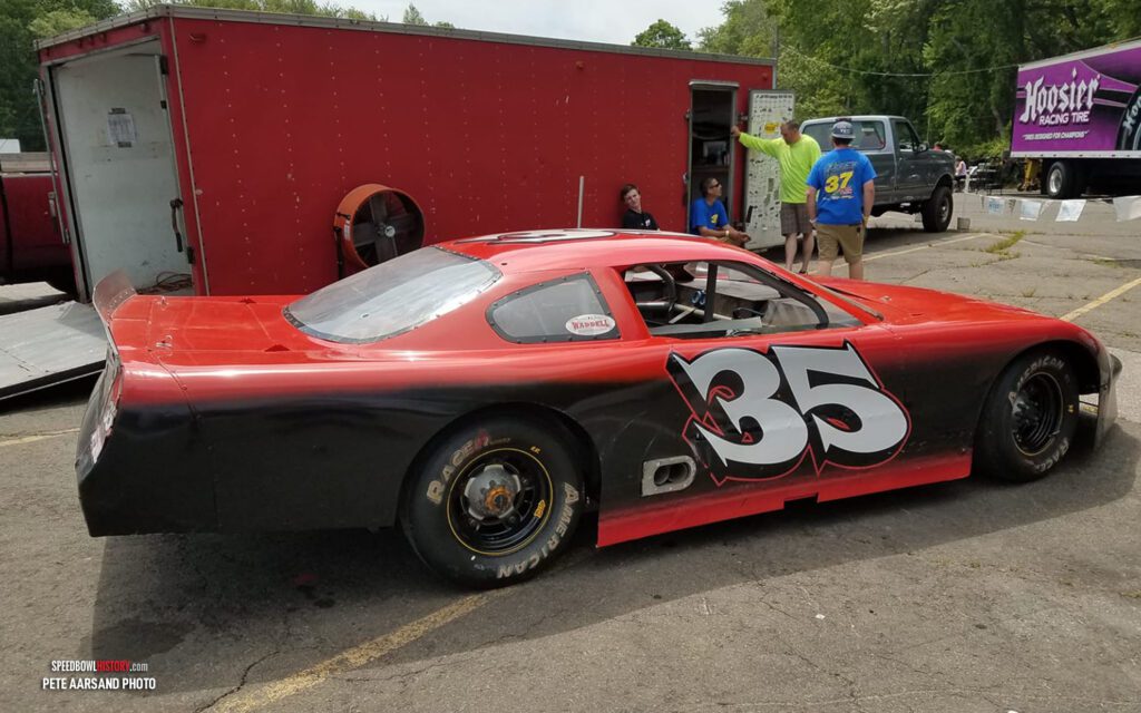 Black and white abstract pattern with concentric circles and wave shapes.