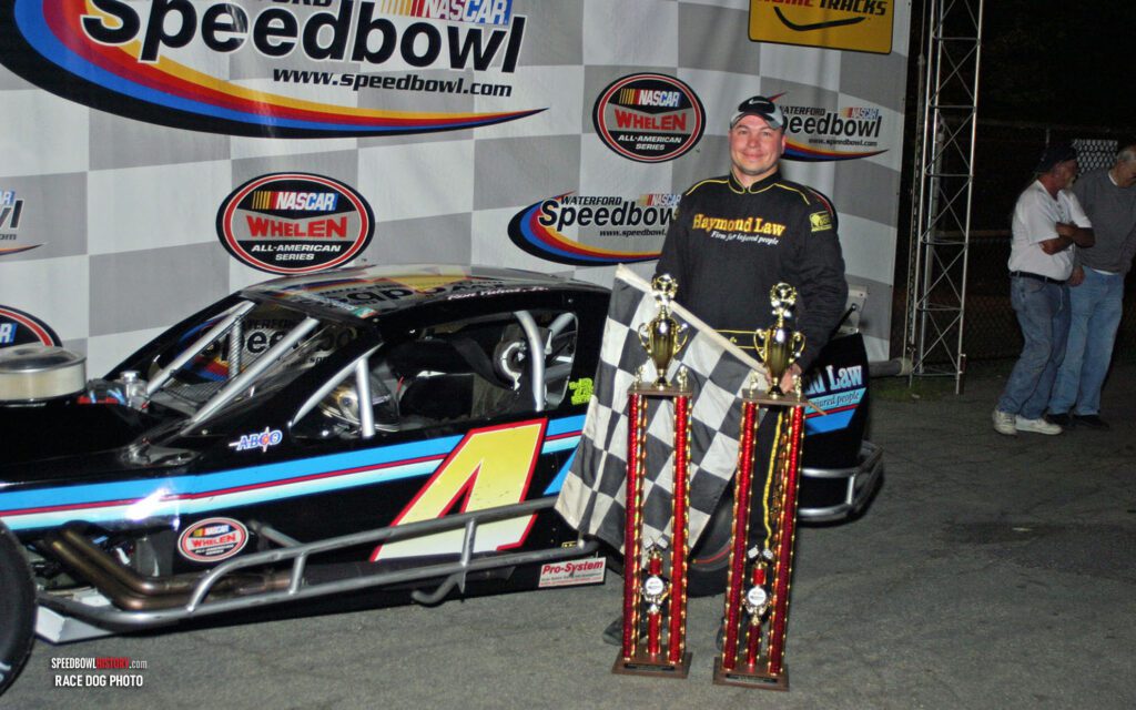 Black and white abstract pattern with concentric circles and wave shapes.