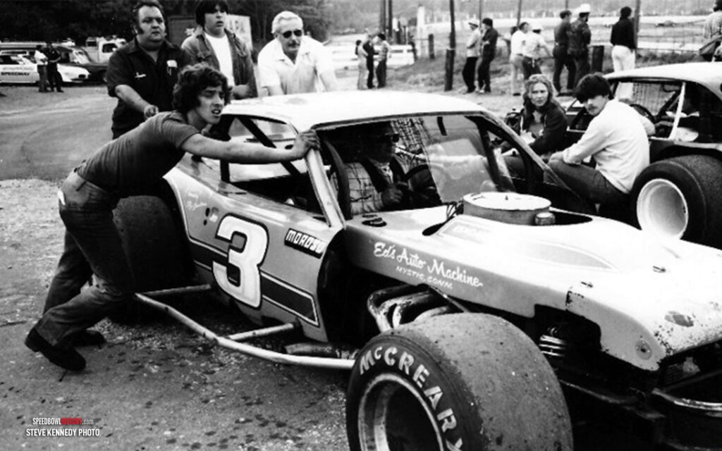 Black and white abstract pattern with concentric circles and wave shapes.