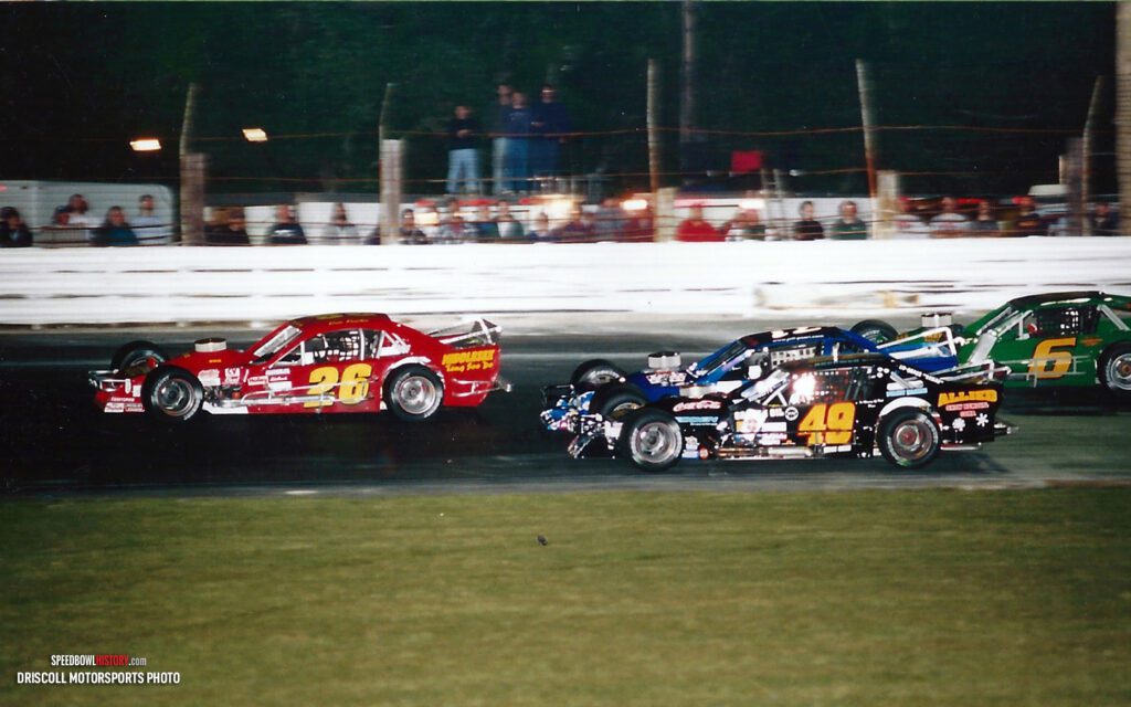 Black and white abstract pattern with concentric circles and wave shapes.