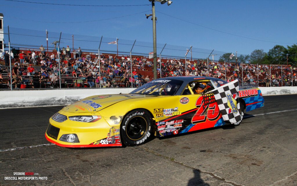 Black and white abstract pattern with concentric circles and wave shapes.