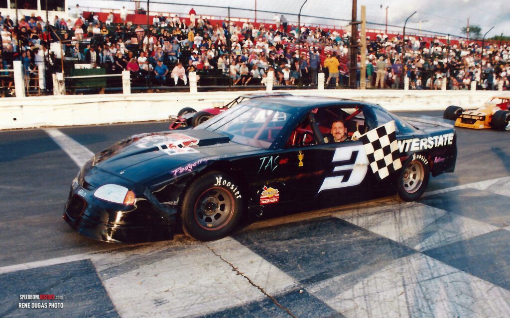 Black and white abstract pattern with concentric circles and wave shapes.