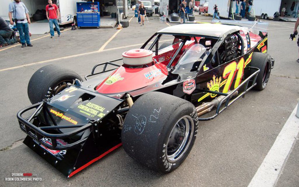 Black and white abstract pattern with concentric circles and wave shapes.