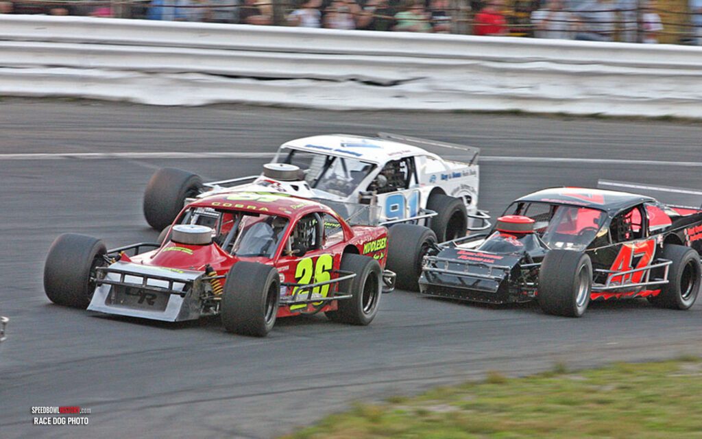 Black and white abstract pattern with concentric circles and wave shapes.