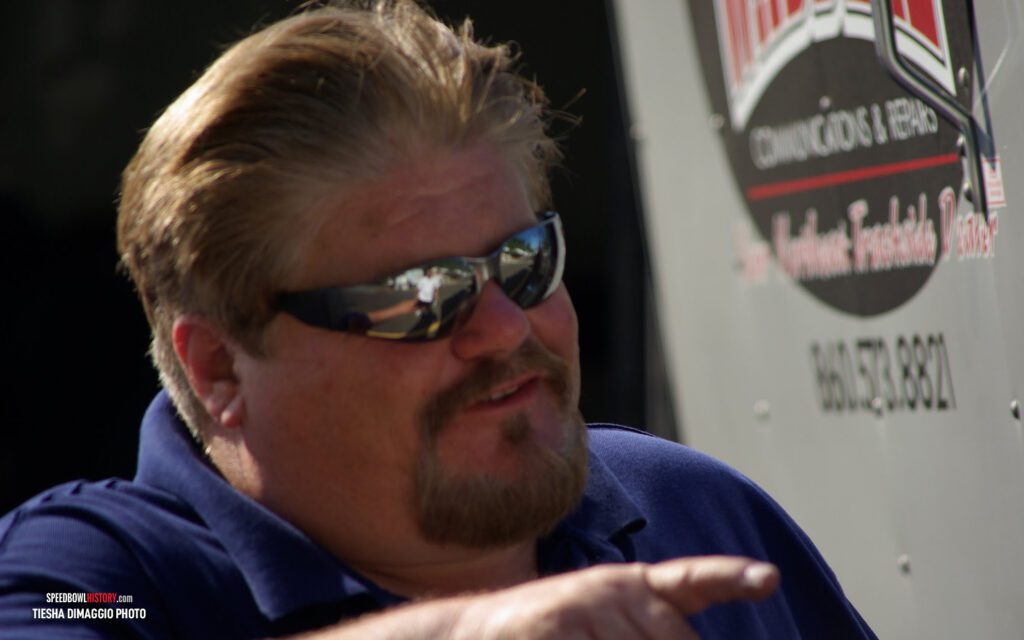 Black and white abstract pattern with concentric circles and wave shapes.