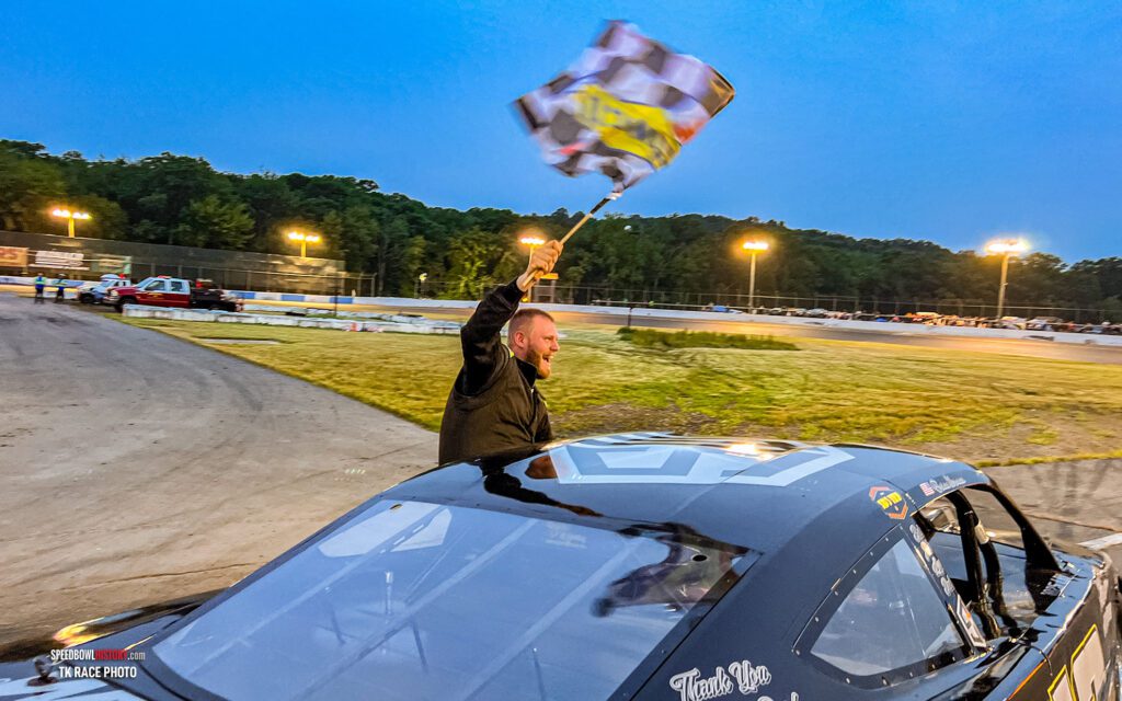Black and white abstract pattern with concentric circles and wave shapes.