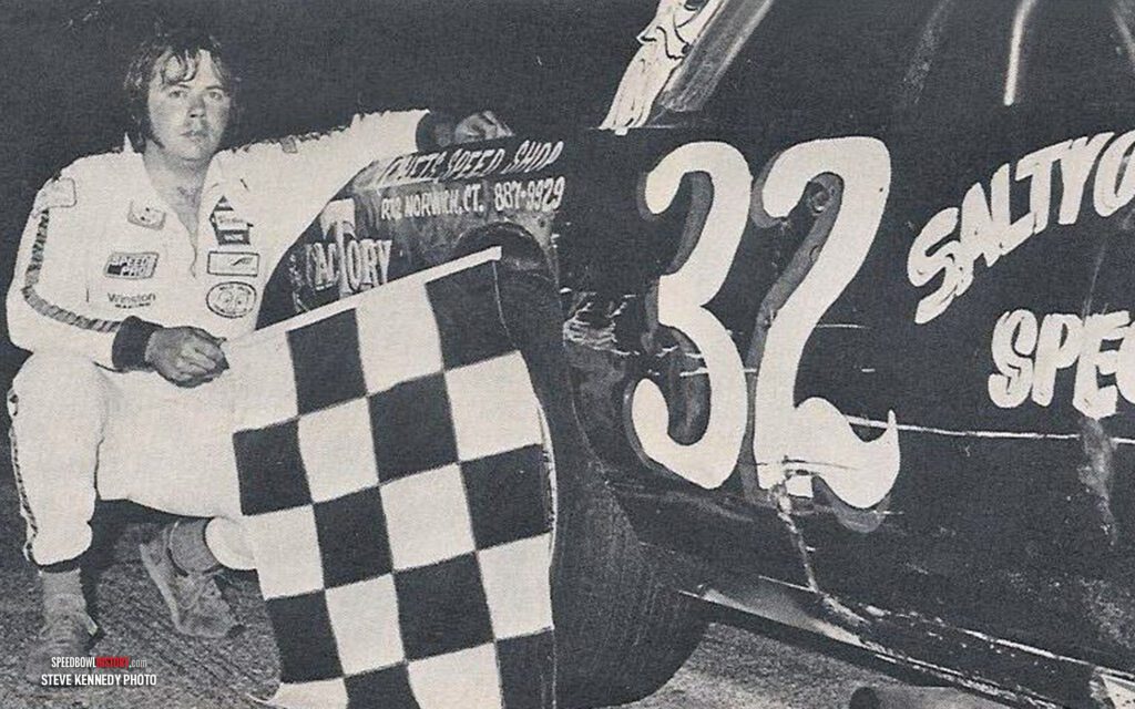 Black and white abstract pattern with concentric circles and wave shapes.