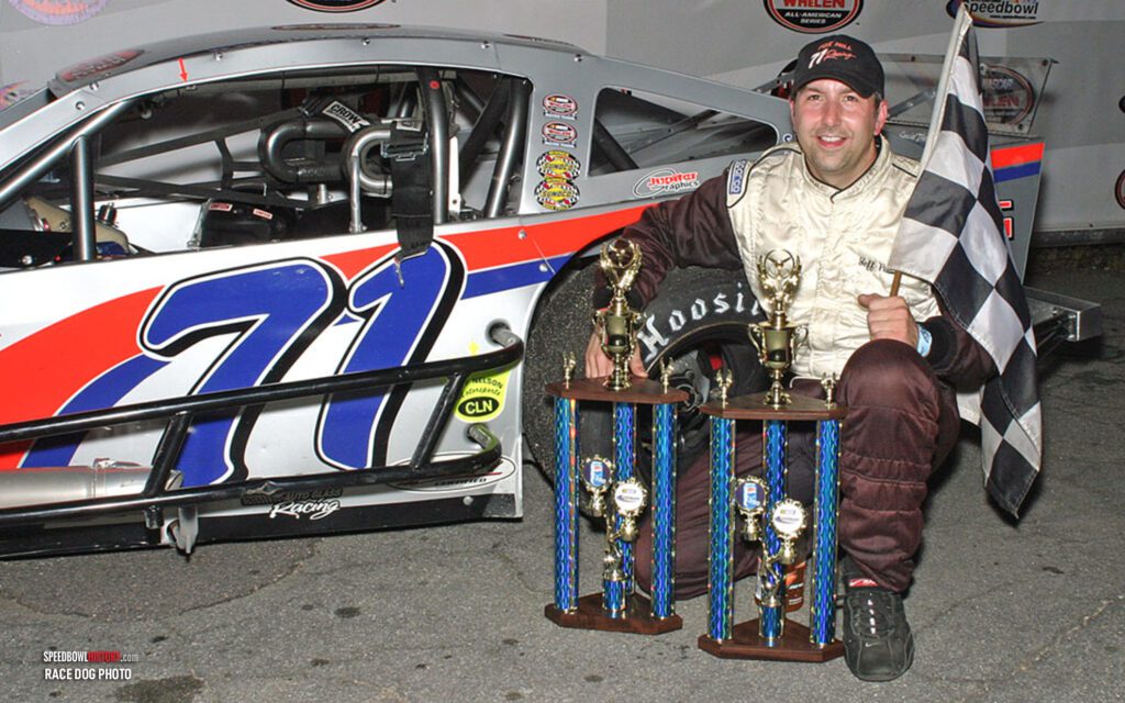 Black and white abstract pattern with concentric circles and wave shapes.