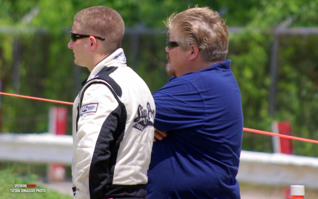 Black and white abstract pattern with concentric circles and wave shapes.