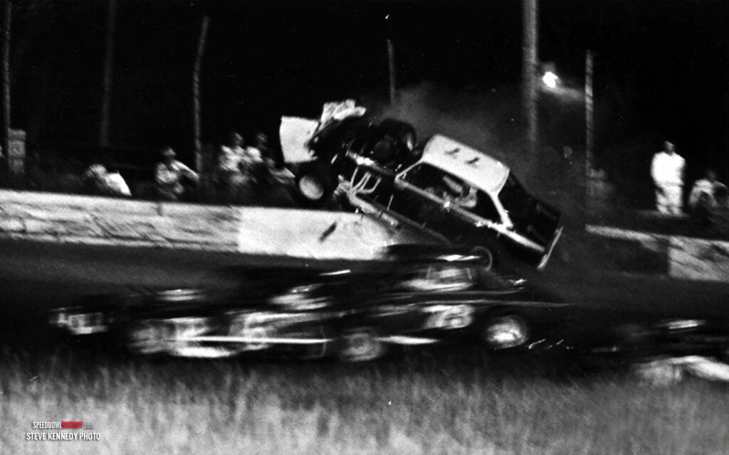 Black and white abstract pattern with concentric circles and wave shapes.