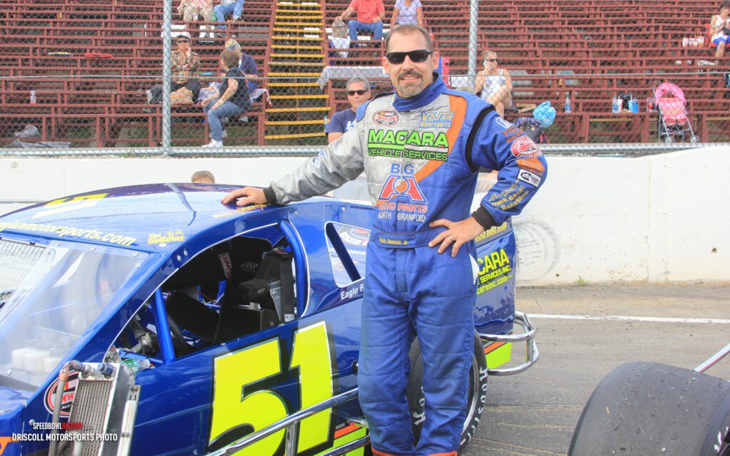 Black and white abstract pattern with concentric circles and wave shapes.