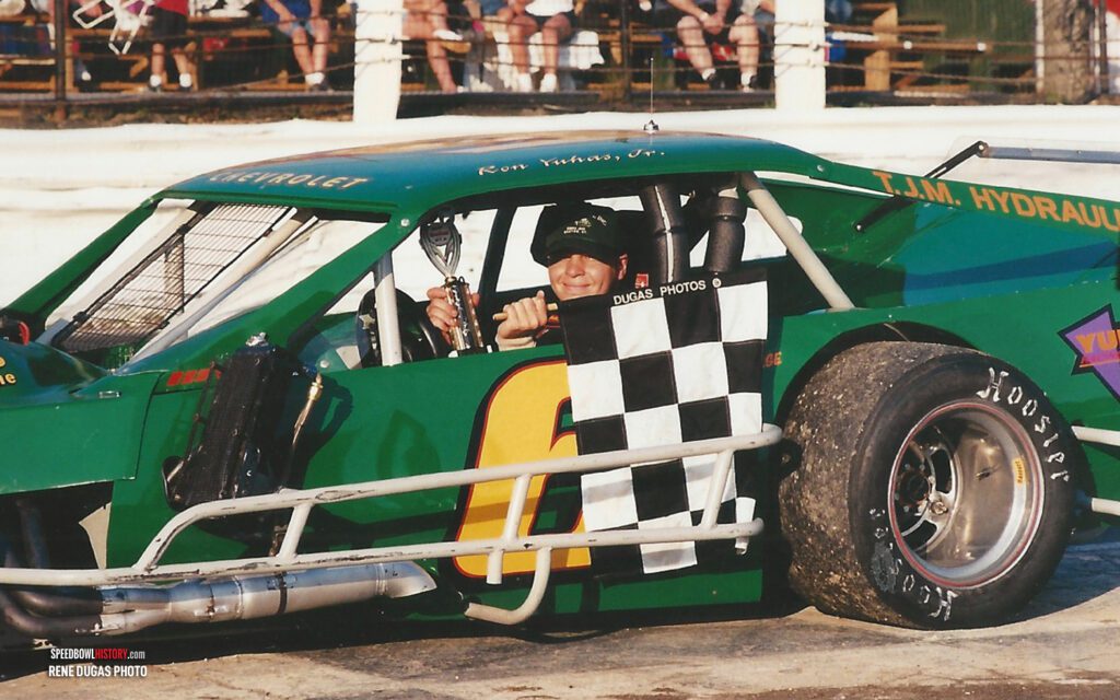 Black and white abstract pattern with concentric circles and wave shapes.