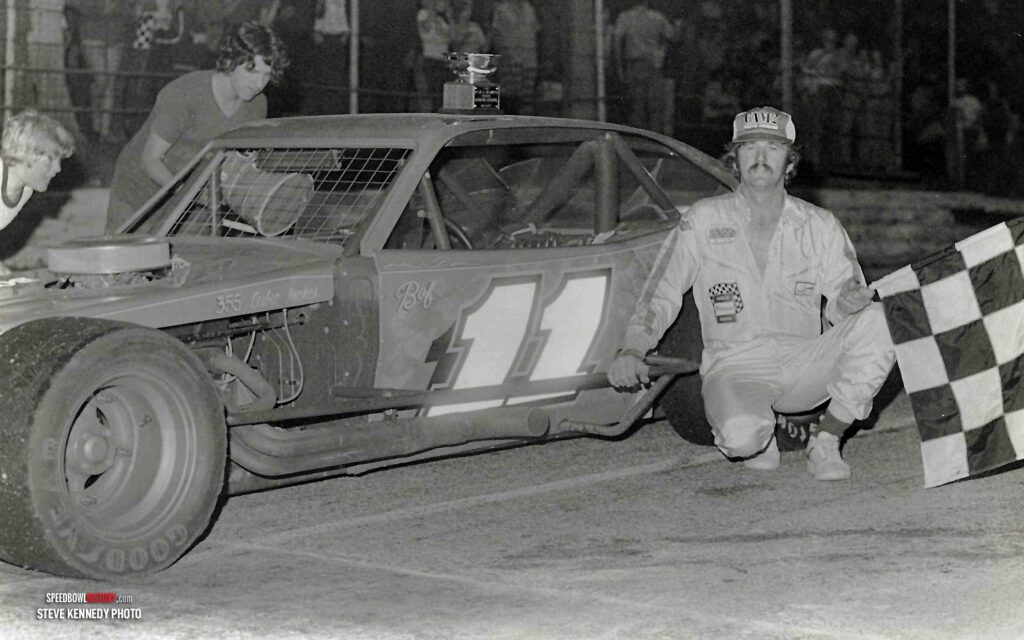 Black and white abstract pattern with concentric circles and wave shapes.