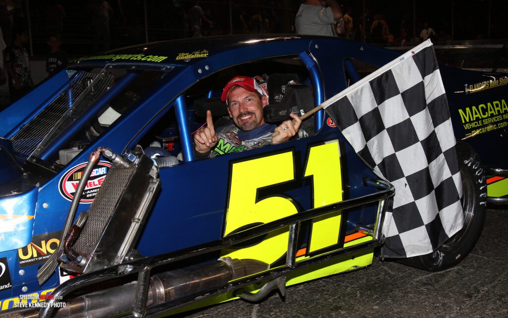 Black and white abstract pattern with concentric circles and wave shapes.